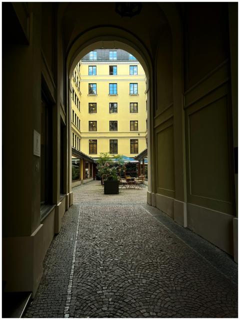 Charming view through an archway into a quiet cour