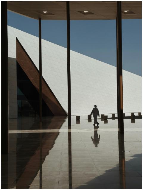 Silhouette of a person walking in a modern archite