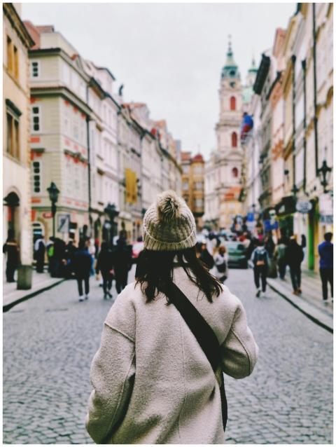 Woman in cozy coat exploring the charming streets