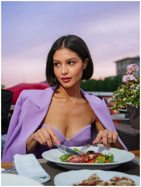 Young woman enjoying an elegant seafood dinner at