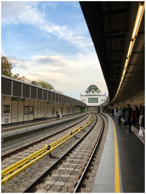 A view of a Vienna metro station under a bright sk