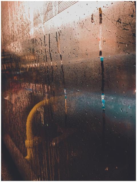 Close-up view of rain-drenched window in Kolkata s