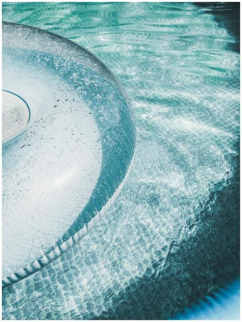 A refreshing scene of a turquoise swimming pool wi