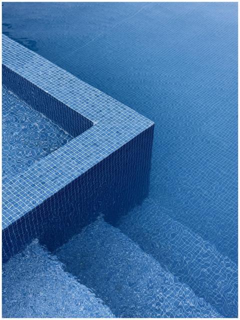 Abstract image of blue tiled pool edges with water