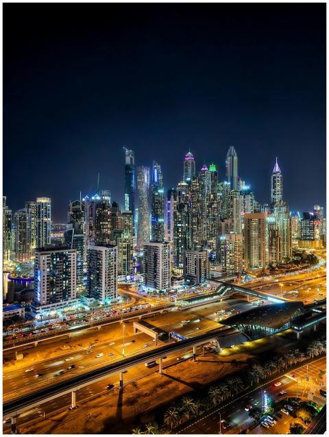 Captivating nighttime aerial of Dubai Marina's ico