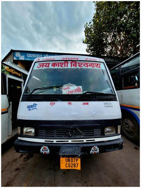 Front view of a vibrant local bus in Rishikesh, ad