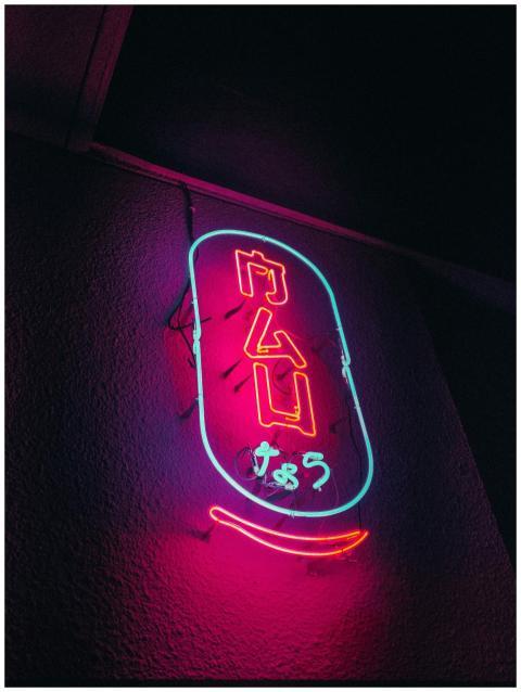 Vibrant neon sign with colorful glow against a dar