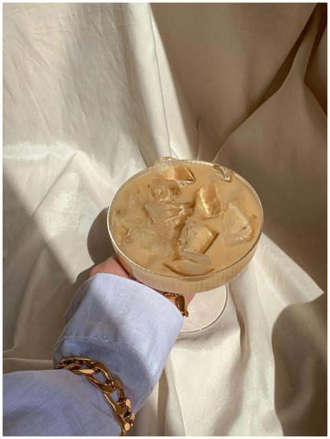 Stylish iced coffee served in a cocktail glass wit