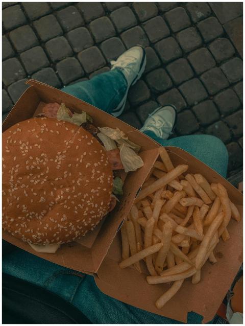 Overhead shot of delicious burger with fries in a