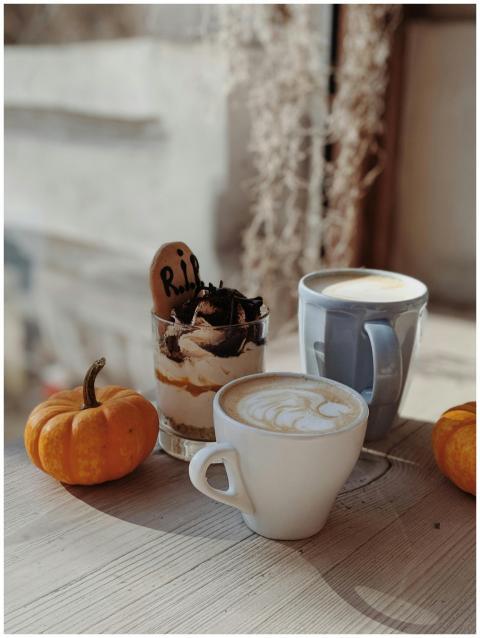 Warm autumn setup with coffee, dessert, and pumpki