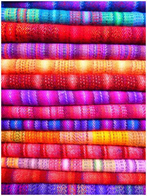 Close-up of vibrant and colorful textiles stacked