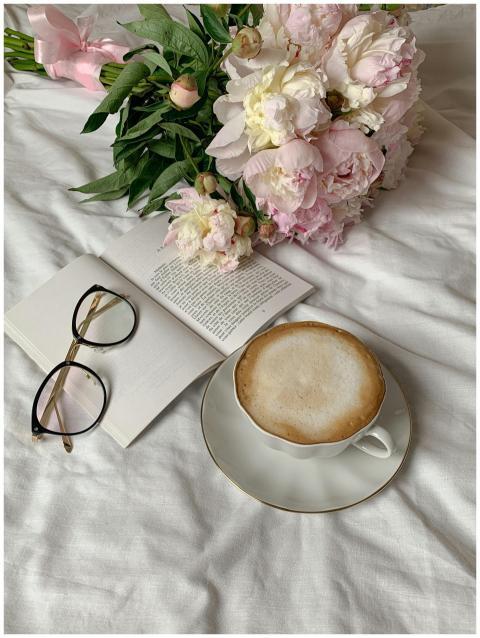 Elegant arrangement with pastel peonies, open book