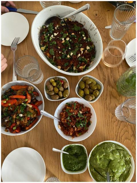 A variety of Mediterranean dishes on a wooden tabl