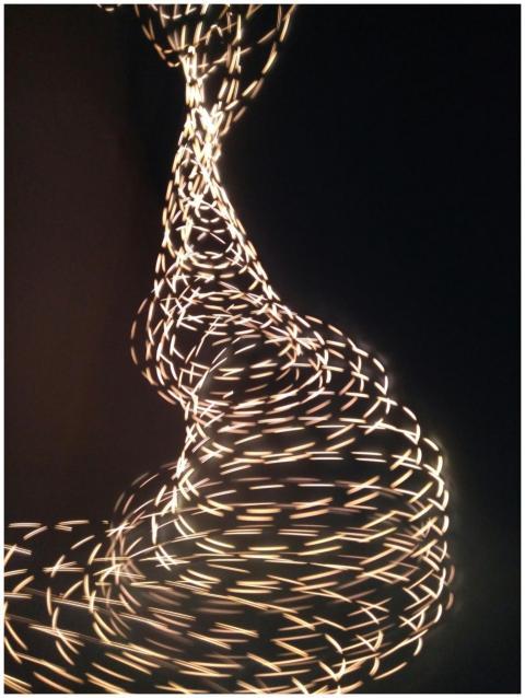 Dynamic abstract light patterns swirling against a