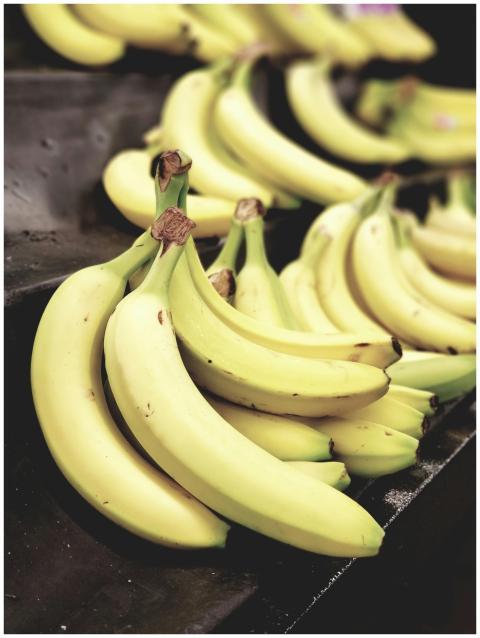 Close-up shot of vibrant yellow bananas on display