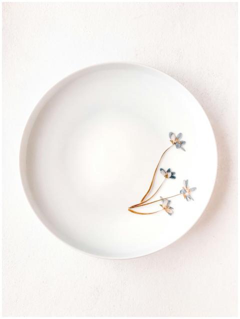 A minimalist white plate featuring three delicate