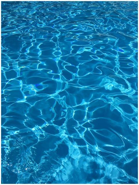 Vibrant blue swimming pool water with dynamic refl