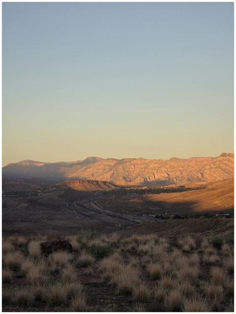 A stunning view of mountains and desert at sunset