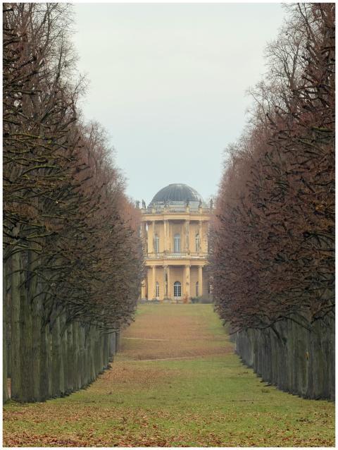 A historic building set at the end of a symmetrica