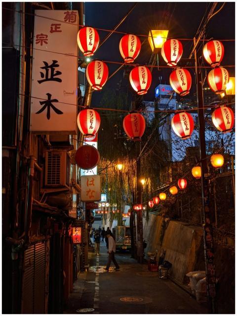 A vibrant night scene of a Tokyo alleyway illumina