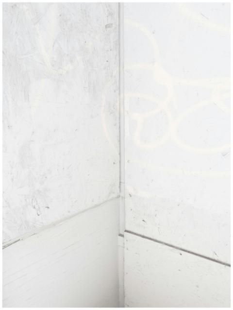 A textured white corner wall with subtle patterns,