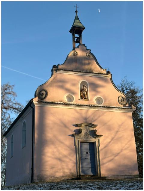 A picturesque baroque chapel bathed in winter sunl