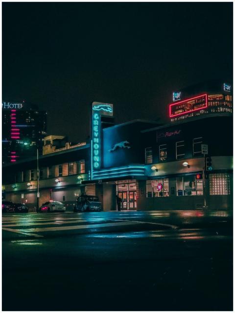 Vibrant nighttime scene of a Greyhound bus station