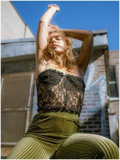 Young woman posing in stylish attire in a vibrant