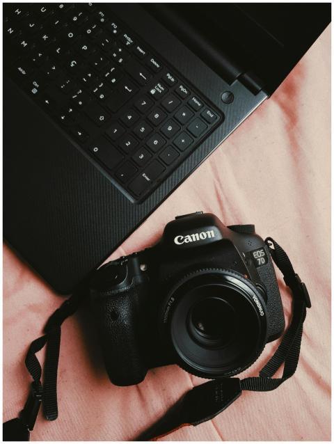 DSLR camera and laptop together, showcasing digita