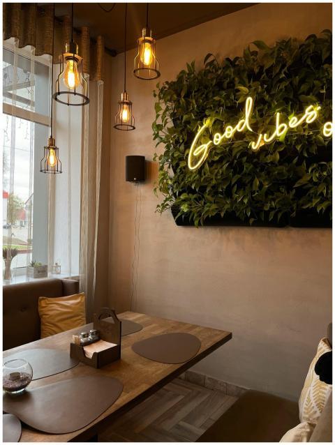 Inviting cafe interior featuring neon 'Good vibes