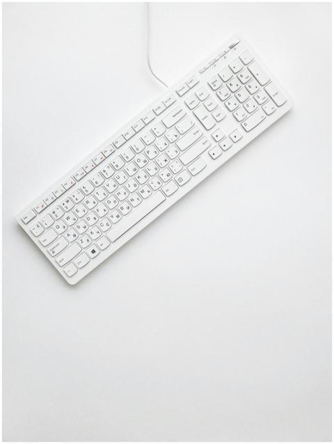 A modern white keyboard on a white background show