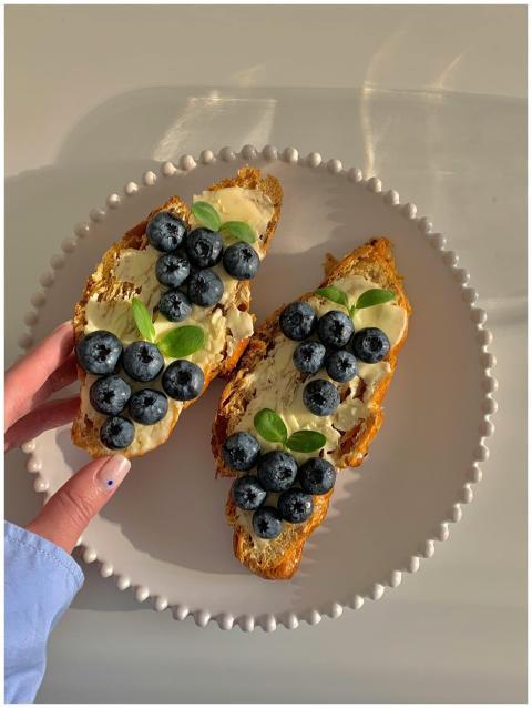 Delicious blueberry and butter toast on a plate he