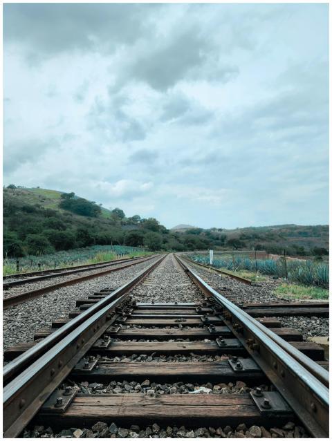 Wide view of railway tracks through rural landscap