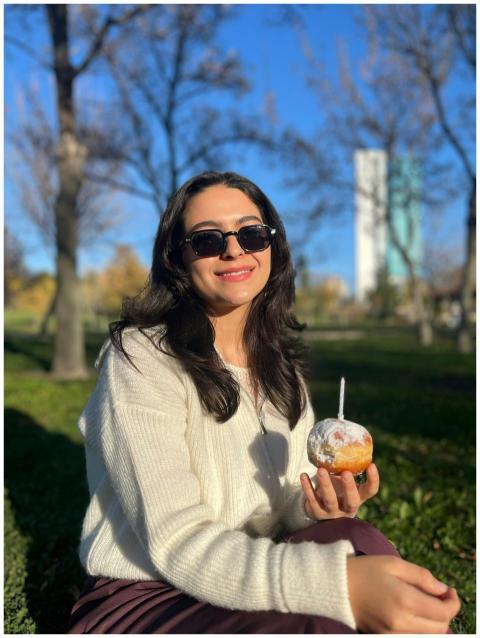 Smiling Woman Enjoying Doughnut