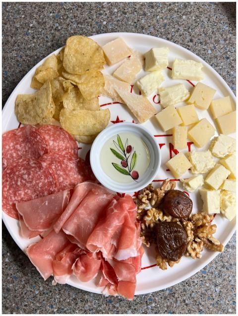 A delicious charcuterie plate featuring meats, che
