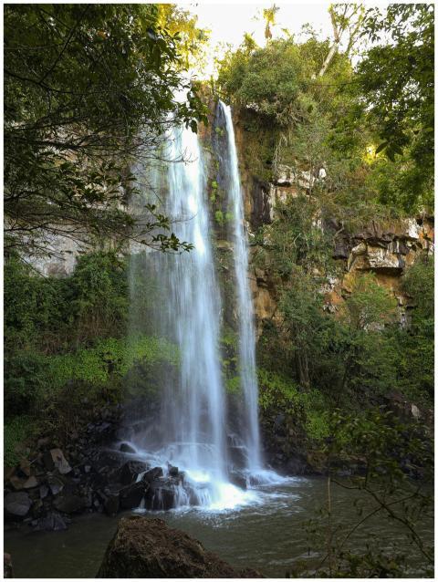 A majestic waterfall cascading down rocky cliffs,