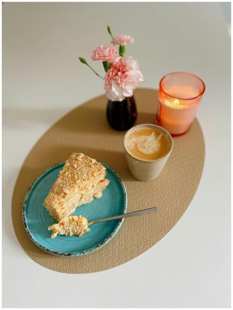 A tranquil scene featuring cake, coffee, flowers,