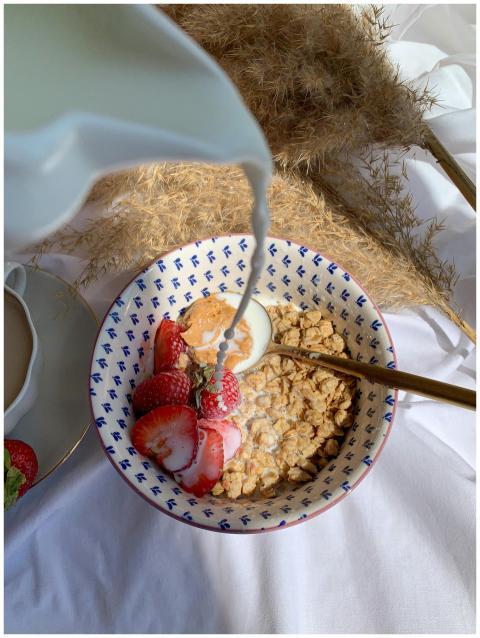 Delicious bowl of granola with fresh strawberries,