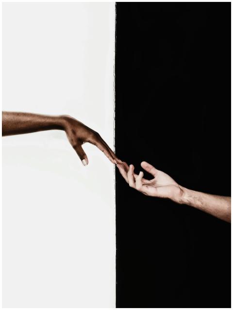 Symbolic image of two hands reaching toward each o
