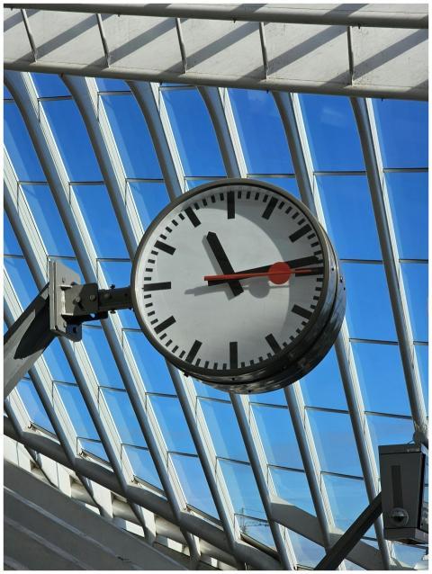 Modern clock beneath steel and glass ceiling at Li