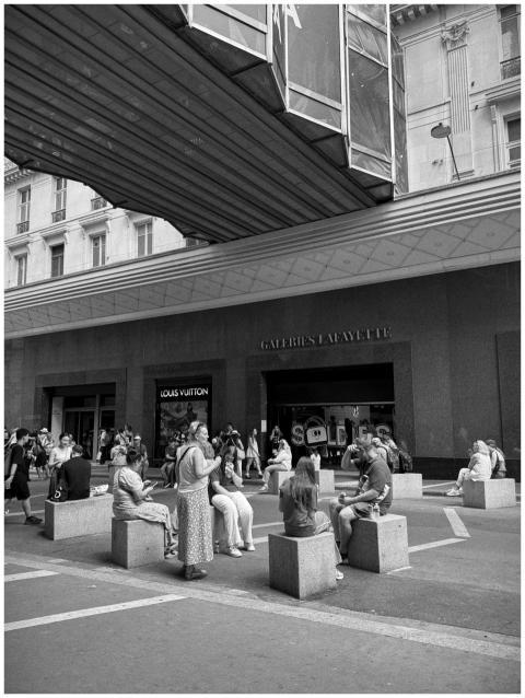 Vibrant street life outside Galeries Lafayette in