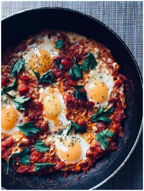 Close-up of a flavorful shakshuka with eggs, tomat
