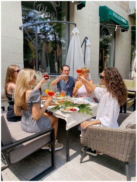 Group of friends enjoying drinks and food at an ou