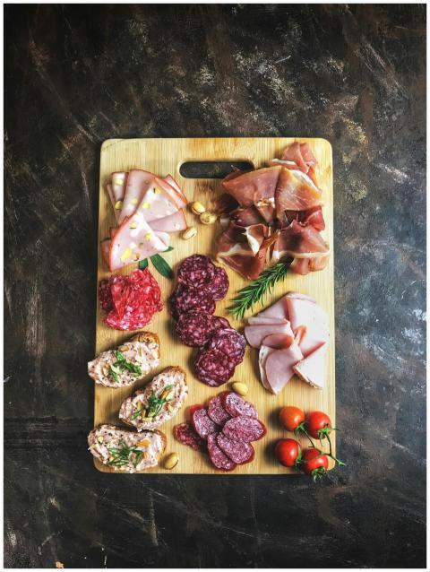 Delicious selection of cold cuts and bread on a wo