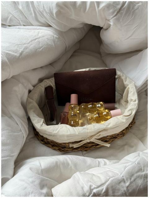 A cozy basket filled with essential oil bottles an