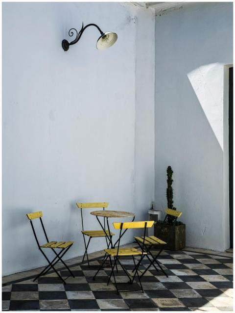 A serene courtyard with yellow chairs in Colonia d