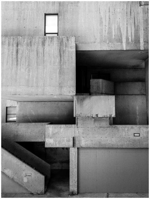 Monochrome image of brutalist architecture featuri