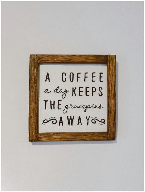 Wooden framed wall art with coffee quote in stylis