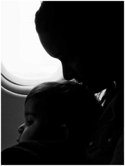Silhouette of a mother and child gazing out an air
