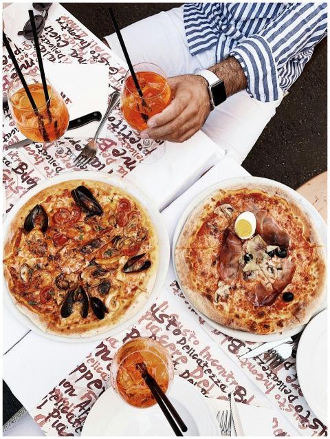 Top view of classic Italian pizzas with Aperol Spr
